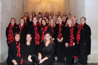 Members of the Belgium Military Wives Choir performing during a remembrance ceremony in Belgium in 2026
