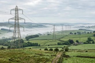 European electricity transmission lines illustrate the EU energy cost dispute over rising power prices.
