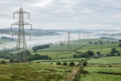 European electricity transmission lines illustrate the EU energy cost dispute over rising power prices.