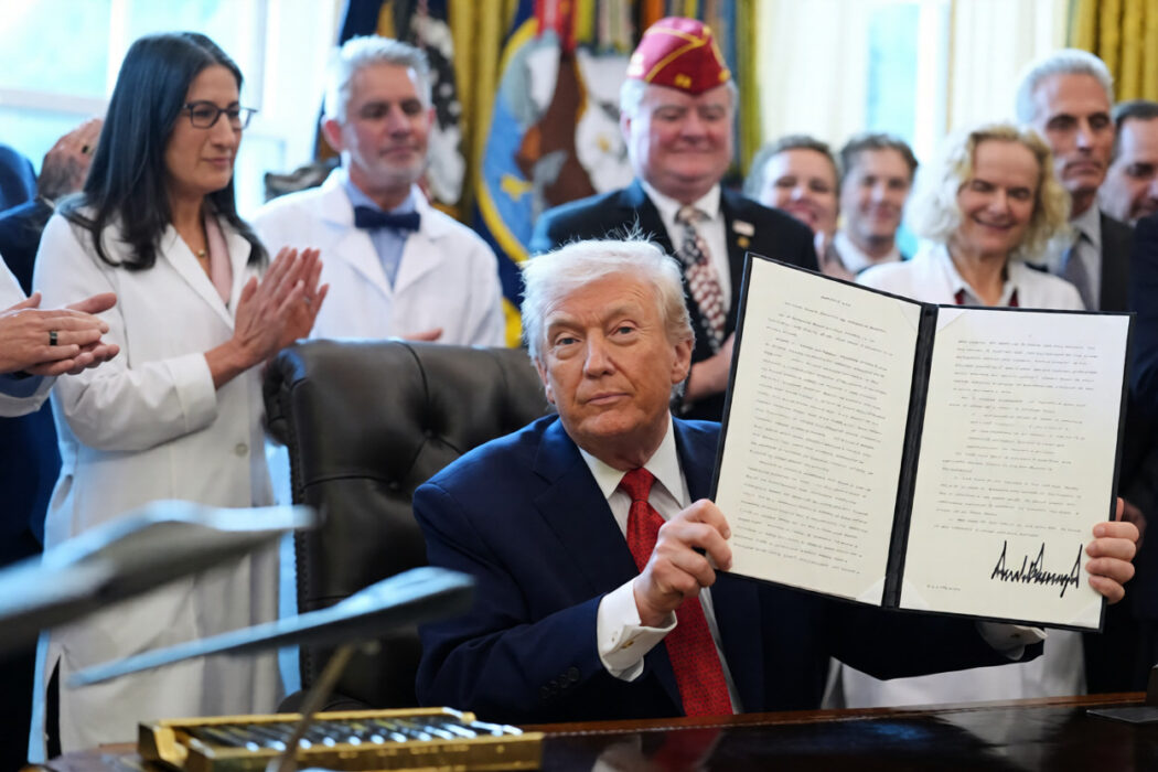 President Donald Trump signing executive order to reclassify marijuana as a less dangerous drug in the Oval Office