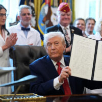 President Donald Trump signing executive order to reclassify marijuana as a less dangerous drug in the Oval Office