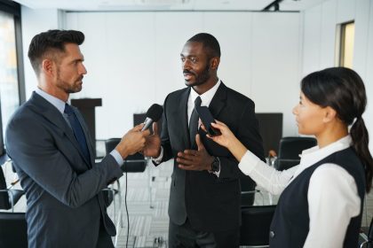 Journalist interviewing a company spokesperson during a press conference on digital PR