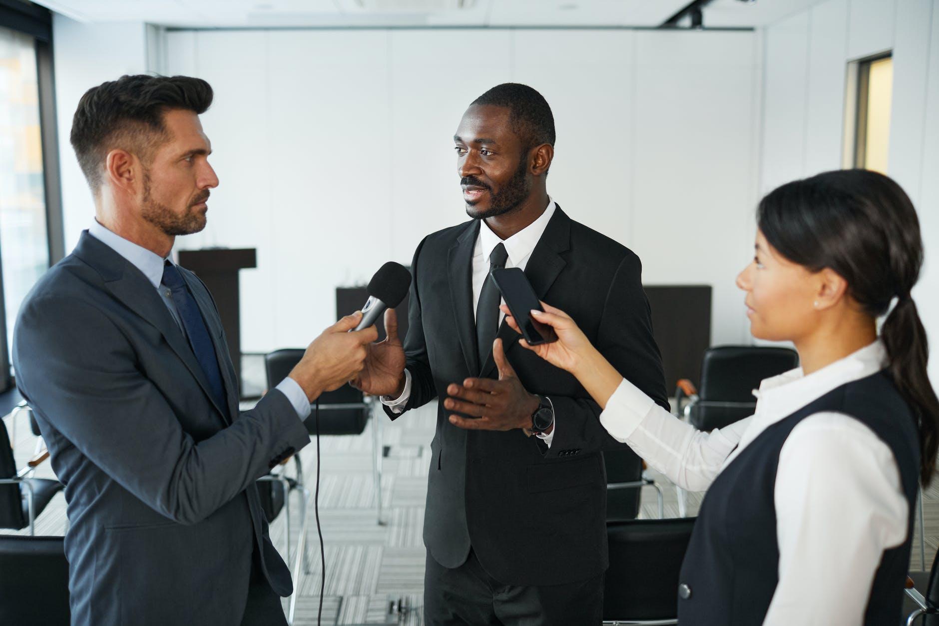 Journalist interviewing a company spokesperson during a press conference on digital PR