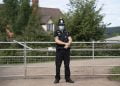 MATHON, UNITED KINGDOM - JULY 12 - JULY 12: A police officer wearing a surgical face mask stands at the entrance to AS Green and Co farm on July 12, 2020 in Mathon, Herefordshire. AS Green and Co, based in Mathon near Malvern, has said 73 of its 200 employees have COVID-19 following an outbreak there. Workers are being asked to isolate on the farm and stay within household groups to reduce the risk of spreading the virus within the workforce. (Photo by Matthew Horwood/Getty Images)