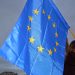 Flag of European Union hold by protester during pro-EU demonstration in Krakow after Polish government decided veto for european budget