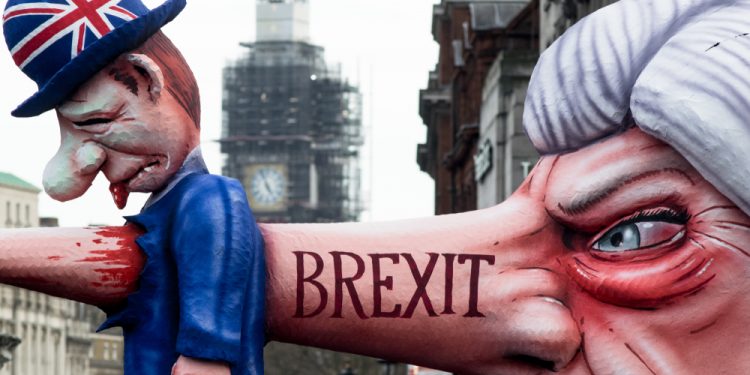 London, U.K., 03/23/2019, March for a “People’s Vote” on Brexit. Cartoon model of Theresa May impaling a Brit with her nose, marker Brexit.