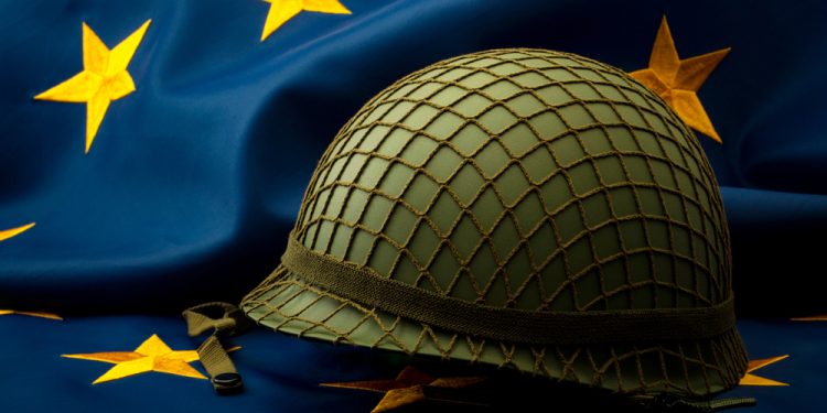 European union army, military uniform and defense of Europe concept with soldier helmet with camouflage pattern and the EU flag in the background