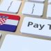 PAY TAX text and flag of Croatia on the buttons on the computer keyboard.