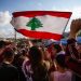 Nabatieh, South Government / Lebanon - 10 20 2019: Lebanese Protesters rising Lebanon Flag in the Sky at the Revolution against the Government