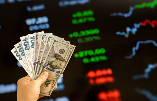 American dollar and Turkish lira on woman's hand and stock market screen, money chart background