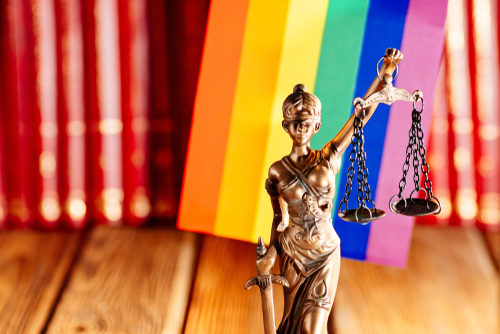 Statue of Justice - symbol of law and justice with lgbt flag. Lgbt rights and law