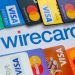 Stone /United Kingdom - June 29 2020: Wirecard logo on paper and VISA and MASTERCARD credit cards around it. Concept. Selective focus.