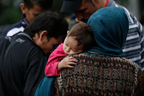 A,Family,Of,Refugees,Rest,In,Victoria,Square,,Where,Migrants