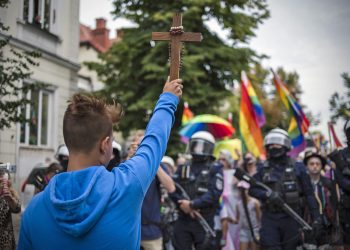 A boy holding a crucifix trying to block the route of the Equality march. On 10th of August the first ever "Equality March" organized by LGBTQ activists took place in the city of P?ock. About a thousand people participated in the event, while hundred of hooligans and nationalists were trying to interrupt the event. Some of the counter protesters have been arrested by the police. (Photo by Attila Husejnow / SOPA Images/Sipa USA)(Sipa via AP Images)