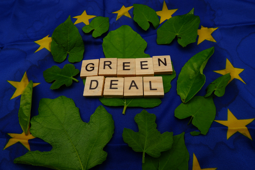 Some,Leaves,with,A,Wooden,Inscription,green,Deal,above,A,European,Flag.,Concept