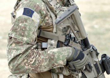 Soldier,With,Assault,Rifle,And,Flag,Of,Europe,On,Military