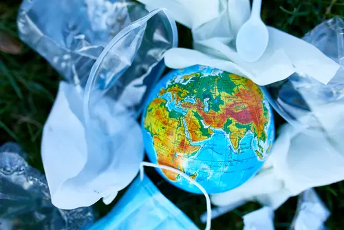 A,Globe,In,A,Pile,Of,Scattered,Garbage,On,A