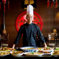 Young,Asian,Chef,Displaying,His,Special,Traditional,Gourmet,On,The