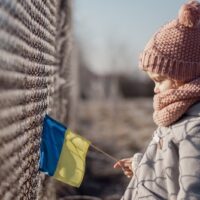 Girl,Holding,Ukrainian,Flag,,Asking,For,Peace,,Children,Against,War,