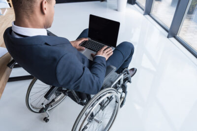 Cropped,Shot,Of,Disabled,African,American,Businessman,Typing,On,Laptop