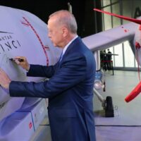 Recep Tayyip Erdogan signing on Turkish made combat drone