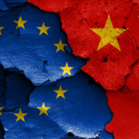 Flags,Of,Eu,And,China,Painted,On,Cracked,Wall