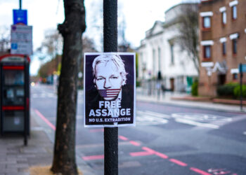 London, UK - March 2020: Signs in support of the Free Julian Assange Campaign on Upper street in North London