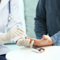 Doctor,Taking,Sample,Of,Diabetic,Patient's,Blood,Using,Lancet,Pen,