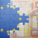 puzzle with the national flag of european union and euro banknote . concept