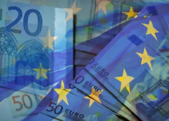 Waving,Eu,Flag,On,A,Euro,Money,-,Background