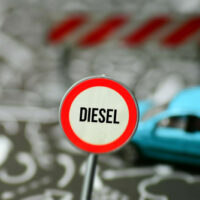A,Car,And,A,Road,Sign,Indicating,Diesel,Driving,Ban