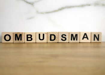 Ombudsman word from wooden blocks on desk, public administration concept