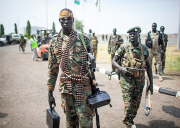 Paloch, South Sudan - March 2, 2014: A South Sudanese soldier carries a machine gun. Credit: Shutterstock