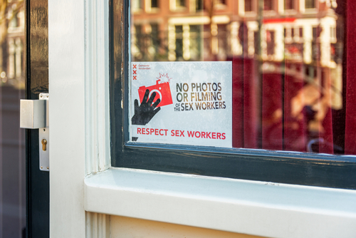 Amsterdam, Netherlands - March 22, 2020: Respect Sex Workers Sign in Red Light District of Amsterdam, Netherlands. People are requested not to film or take photos.