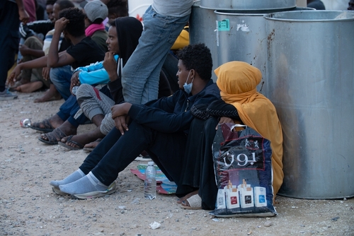October 10, 2021: Migrant women and men wait by the United Nations High Commissioner for Refugees (UNHCR) headquarters on in Tripoli, Libya.