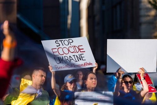 Vancouver, Canada - Jun 6, 2023 - People holding blue cloth and banners asking to stop ecocide in Ukraine