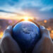 The globe Earth in the hands of man against the night city. Concept on business, politics, ecology and media. Earth day abstract background. Elements of this image furnished by NASA.