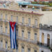Havana, Cuba - Jan 01, 2020: Large Cuban flag hanging vertically on a facade of colonial building Inglaterra Hotel in the historical center of Old Havana. Space for copy.
