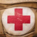 medical aid symbol on a vintage jute army bag