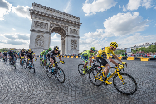 PARIS, FRANCE - JULY 24, 2016 : The road racing cyclist Christopher Froome, wearing the leader's yellow jersey in front of Arc de Triomphe during the Tour de France 2016 on the Champs Elysees Avenue.