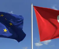 Flying,Flags,Of,The,European,Union,And,Tunisia,On,Sky
