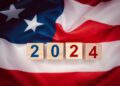 United States presidential election 2024. Wooden cubes with the letters 2024 on the American flag background. Politics and voting conceptual