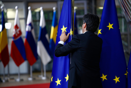 Brussels, Belgium. 28th May 2019.An official adjusts an EU flag in the lobby of the European Council building during the EU Summit.