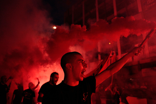 Supporters of the extreme far-right Golden Dawn party celebrate after the early election results, at the central offices of the Golden Dawn in Thessaloniki, Greece 17 June 2012.