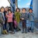 Velykyi Bereznyi, Ukraine - February 28, 2021: Group of cute gypsy kids in ghetto. Ukrainian Roma children in Carpathian mountains.