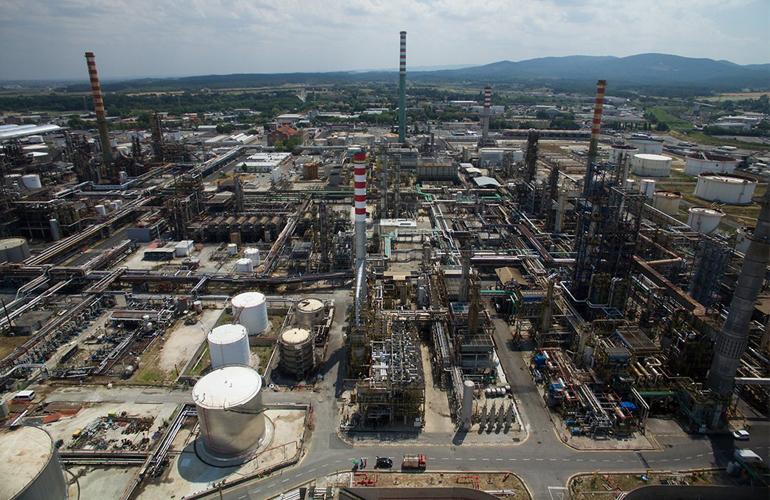 Eni CEO oil market outlook featuring a modern energy refinery supporting global oil production