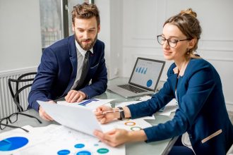 Business professionals reviewing financial reports to support transparent business practices and public trust