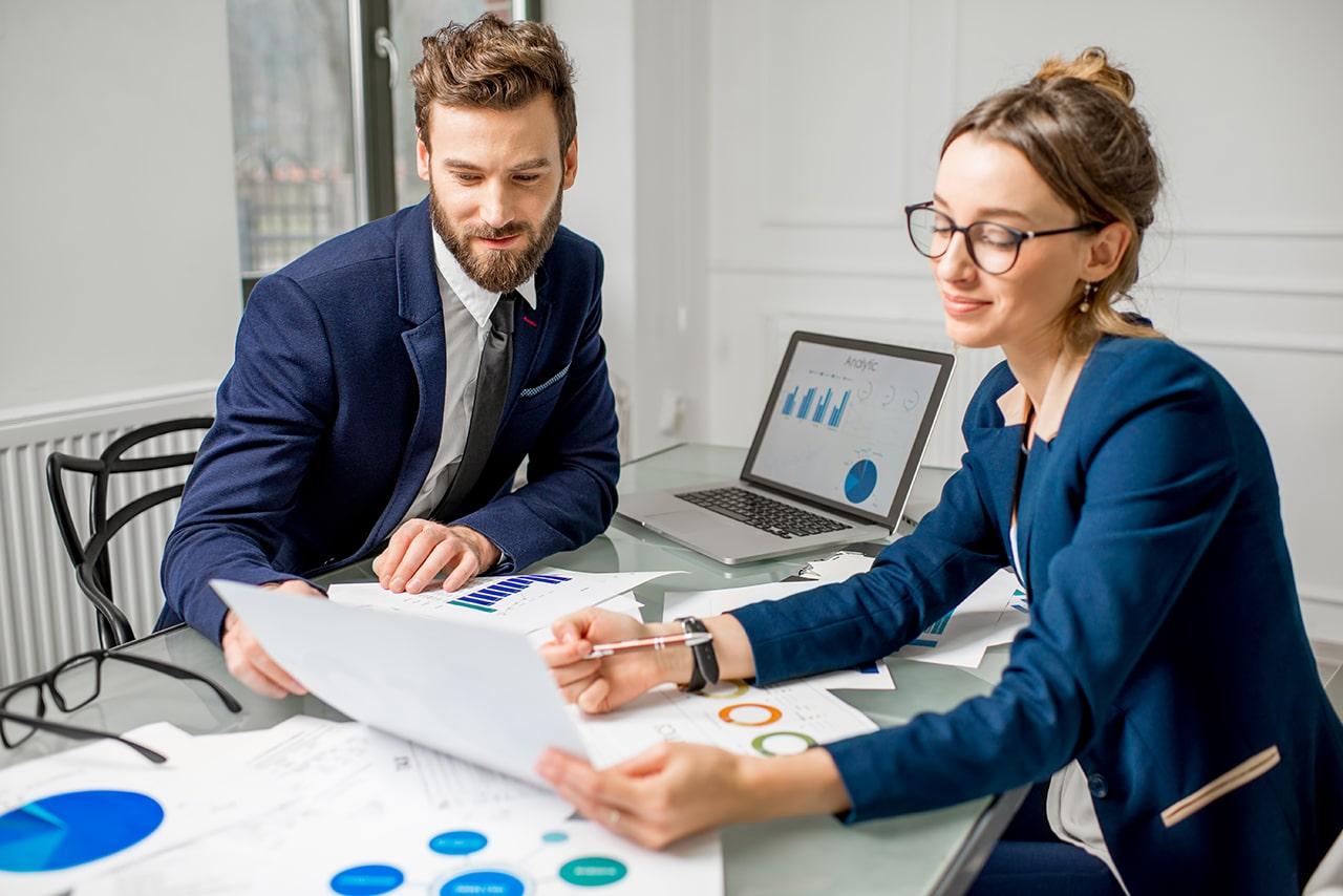 Business professionals reviewing financial reports to support transparent business practices and public trust