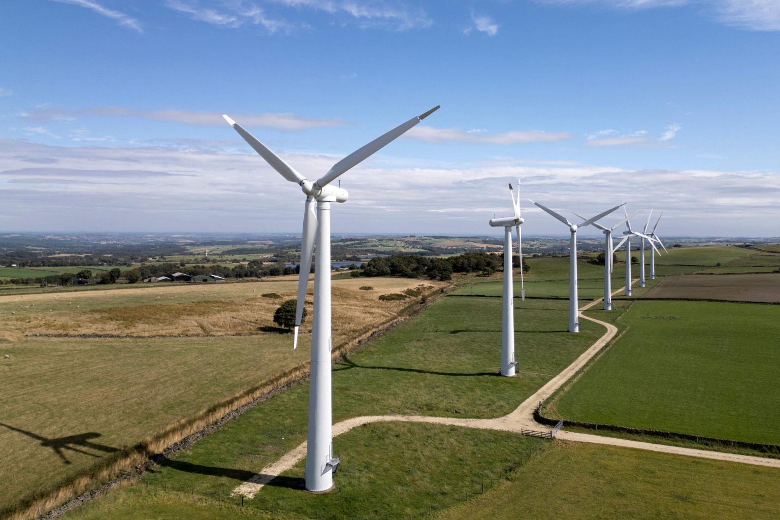 UK renewable energy expansion featuring offshore wind turbines near the British coastline in 2026