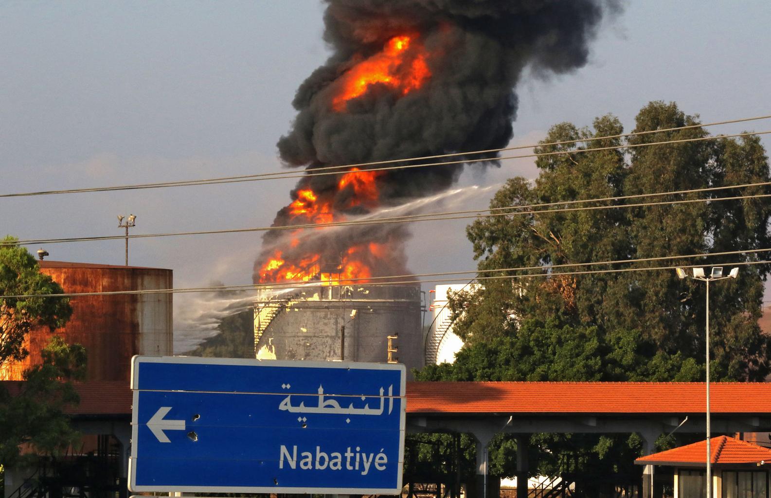 refinery attack impact showing damaged pipelines and burning energy infrastructure